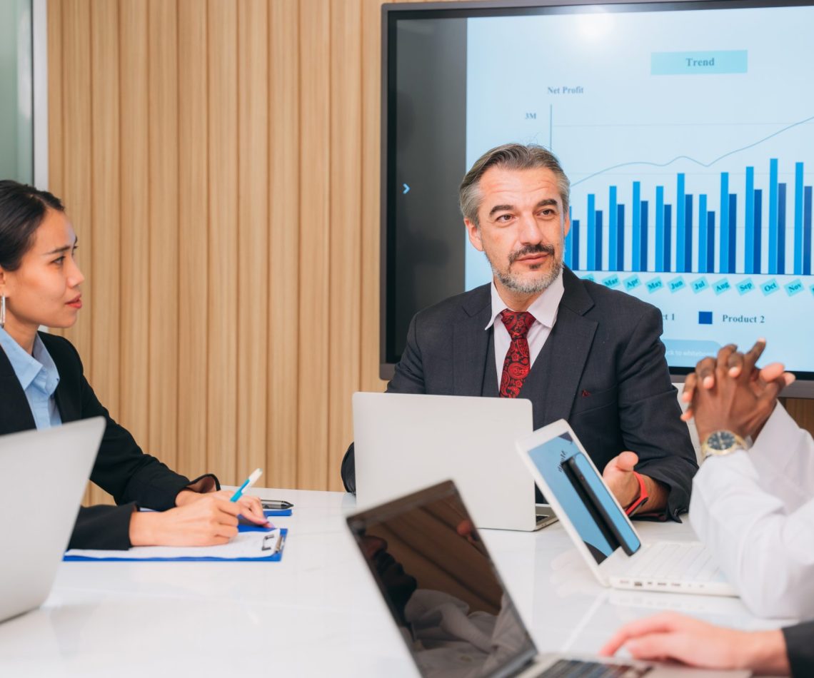 Group of business meeting about documents and ideas at the office desk. Discussion among businesspeople on the latest developments.