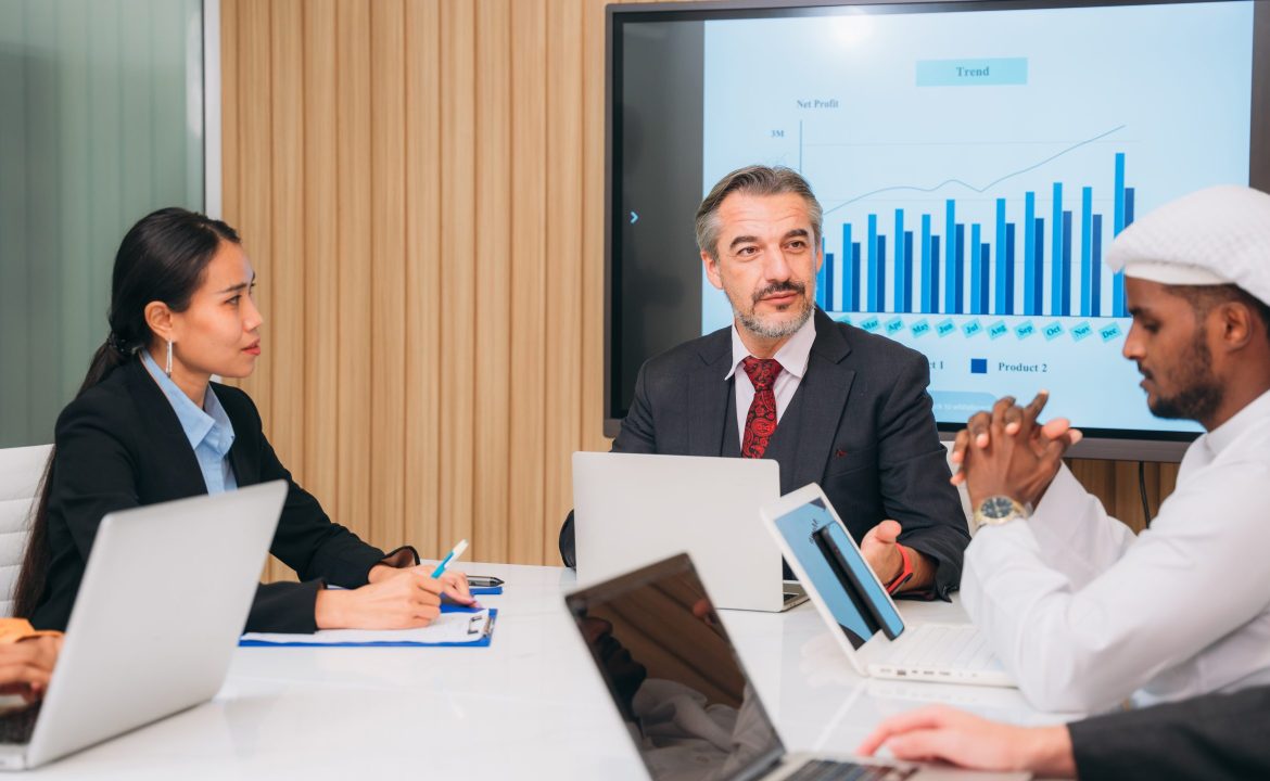 Group of business meeting about documents and ideas at the office desk. Discussion among businesspeople on the latest developments.