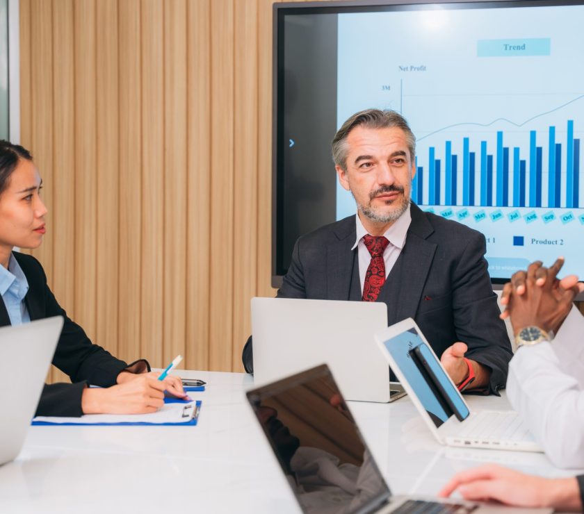 Group of business meeting about documents and ideas at the office desk. Discussion among businesspeople on the latest developments.
