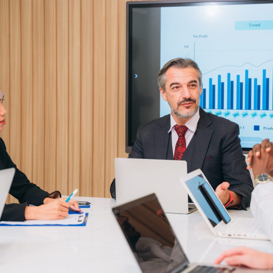 Group of business meeting about documents and ideas at the office desk. Discussion among businesspeople on the latest developments.